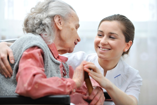 nurse helping patient in wheelchair